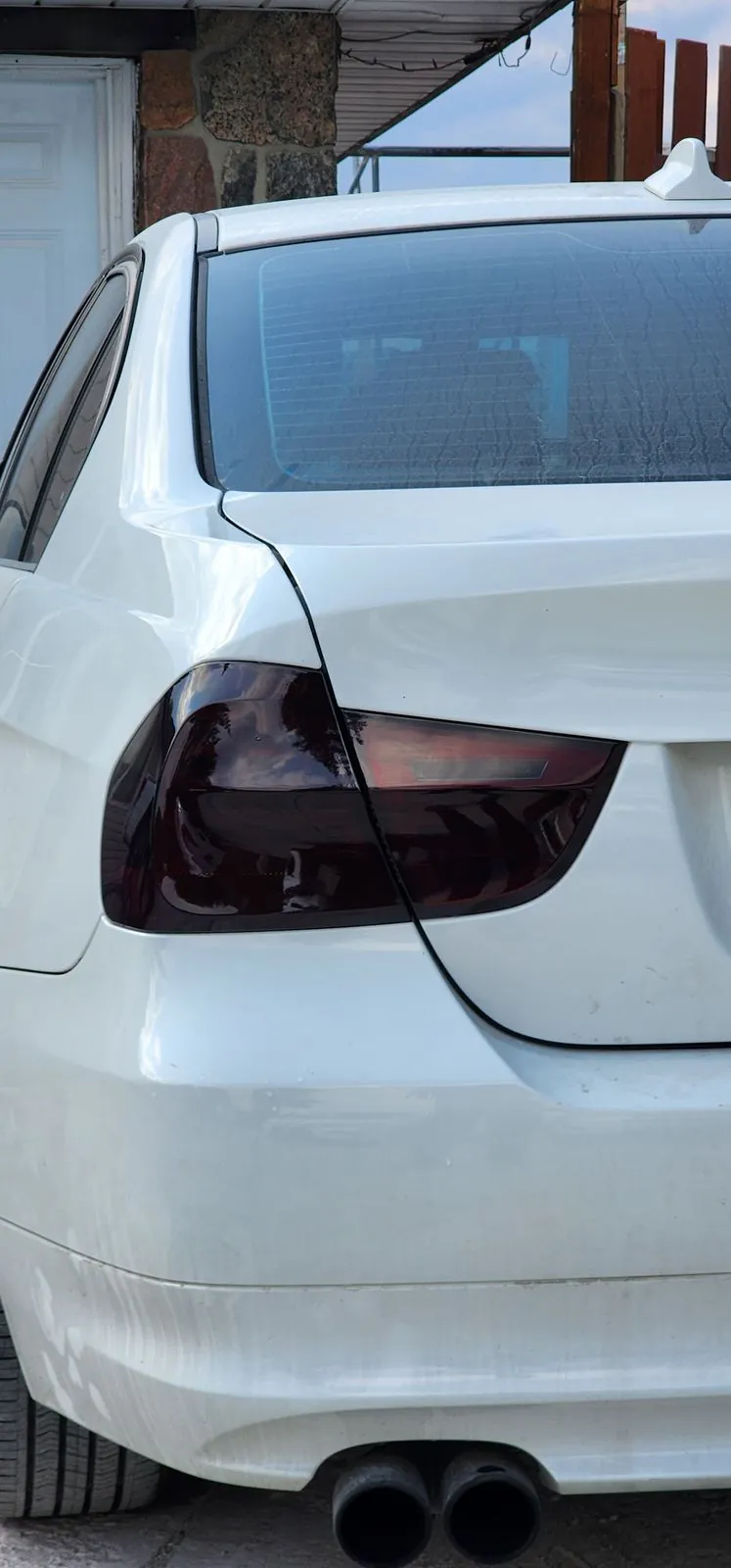 Smoked taillight tint on a white BMW sedan