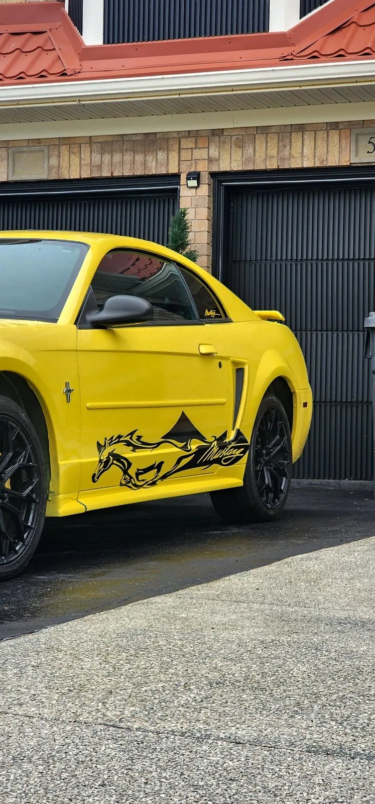 Running horse side decal on a yellow Ford Mustang