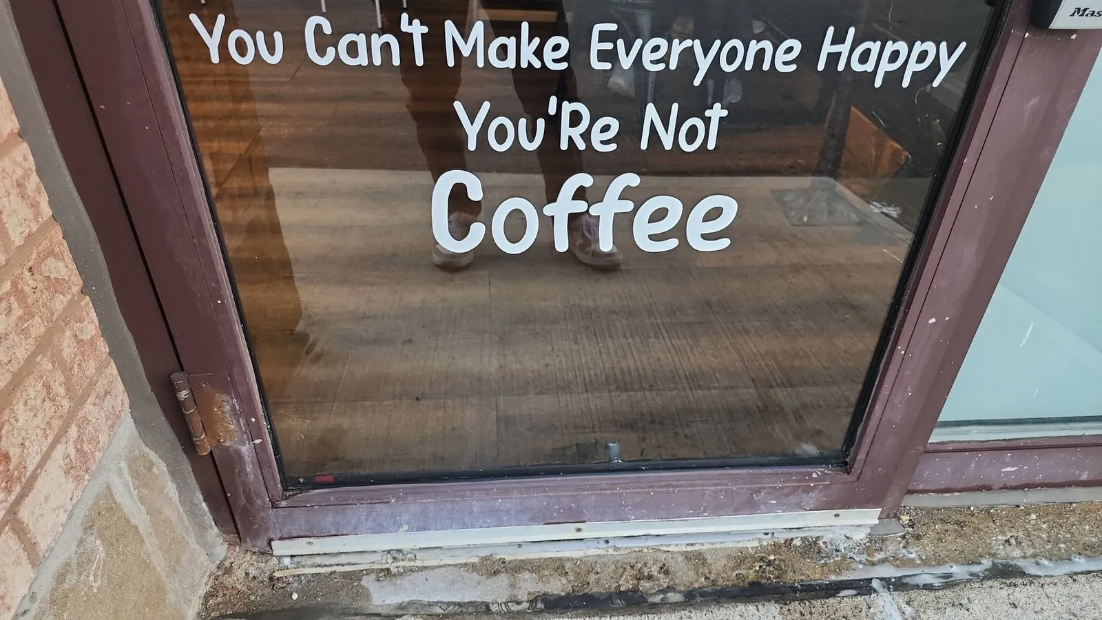 Close detail of coffee-themed window lettering